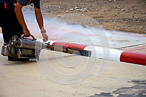 Man worker fogging insecticide to eliminate mosquito for preventing spread dengue fever and zika virus