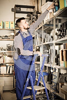 Man worker going through sanitary engineering details in workshop