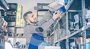 Man worker going through sanitary engineering details in workshop