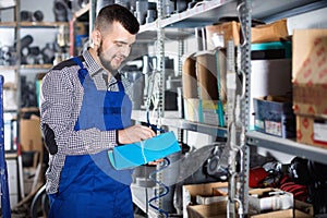 Man worker going through sanitary engineering details in workshop