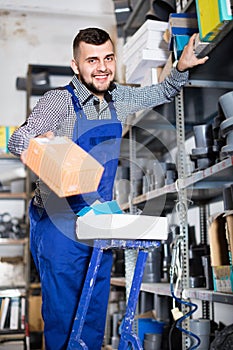 Man worker going through sanitary engineering details in workshop