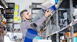 Man worker going through sanitary engineering details in workshop