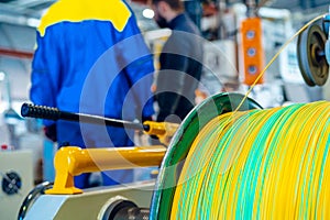 Man worker in manufacturing plant at cable factory machine control computer panel