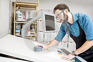 Man working with spectrometer at the manufacturing photo