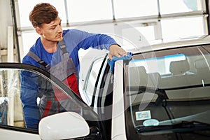 Man worker polishing car on a car wash