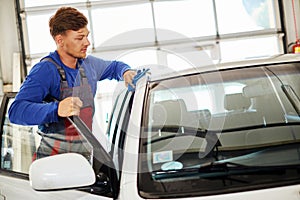 Man worker polishing car on a car wash