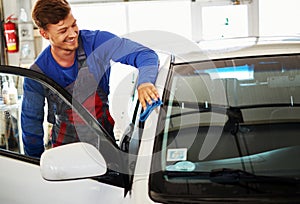 Man worker polishing car on a car wash