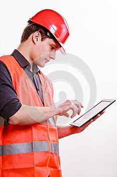 Man worker in safety vest hard hat using tablet