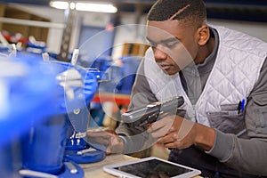 Man worker scanning packages with barcode scanner in warehouse