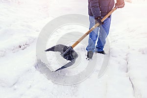 Man worker shovel cleaning snow winter street in front of house after big snowstorm