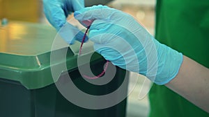 Man worker tighten nylon tie on box. Spbd warehouse employee use plastic cable to close box