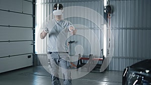 Male mechanic in VR headset checking a car