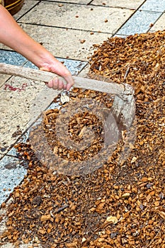 Man worker using hoe equipment on the soil clay dirt