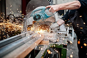 Man, worker using a sliding compound mitre saw photo