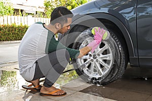 Man worker washing car`s on a car wash. Cleaning concept.