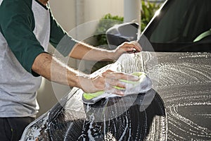 Man worker washing car`s on a car wash. Cleaning concept.