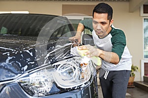 Man worker washing car`s on a car wash. Cleaning concept.
