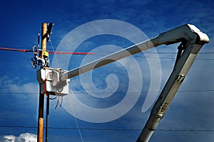 Man Worker Working on Power Lines Crane Bucket High in the Air Dangerous