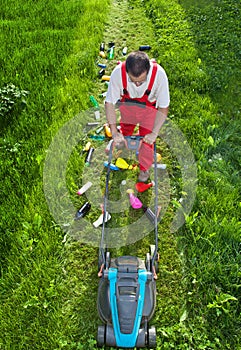 Man working against nature - concept with plastic spewing lawn m