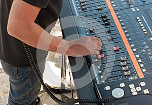 Man working with analogue sound mixing table