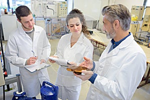 Man working with apprentices in printing house