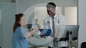 Man working as doctor using computer and documents