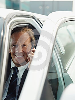Man Working As Driver Of Limousine Answering Phone Call