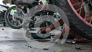 a man is working as a motorcycle repair shop