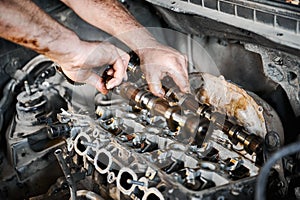 Man working in auto servicing center, garage, workshop.