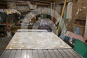 A man working behind a milling machine