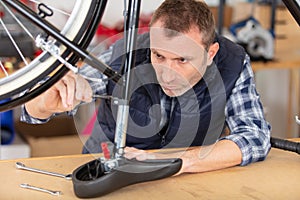 man working in bicycle repair shop