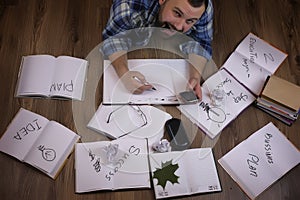 Man working with book on the floor