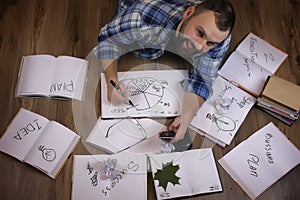 Man working with book on the floor