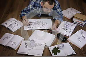 Man working with book on the floor