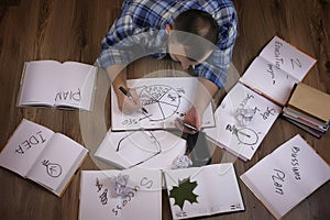 Man working with book on the floor