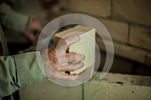 Man working on a brick wall