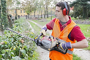 Man working bush trimmer