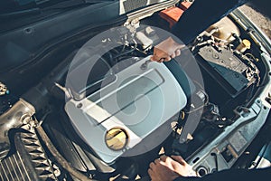 Man working in car motor.