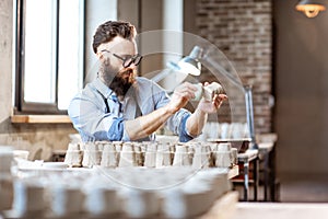 Man working with ceramics at the pottery