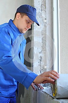 Man in working clothes places the foiled