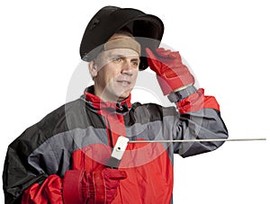 The man in working clothes and welder mask