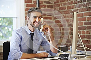 Man Working At Computer In Contemporary Office