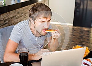 Man working at the computer and eating fast food. Unhealthy Life