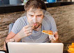 Man working at the computer and eating fast food. Unhealthy Life