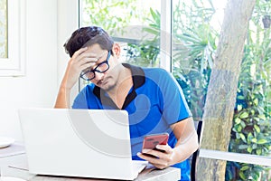 Man working on computer and having headache