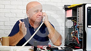 Man Working in Computer Maintenance Talk to Telephone and Gesticulate