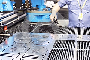 Man working at computer numerical control programmable CNC machine for metal