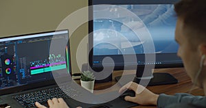 Man working on computer with Two Monitors Video editing. Monitor the computer and capture the work of the program for