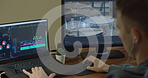 Man working on computer with Two Monitors Video editing. Monitor the computer and capture the work of the program for