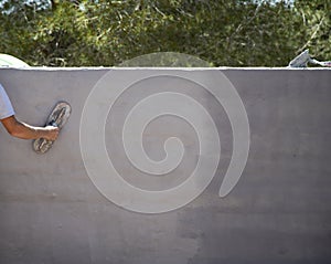 Man working on the construction of the printed concrete wall photo